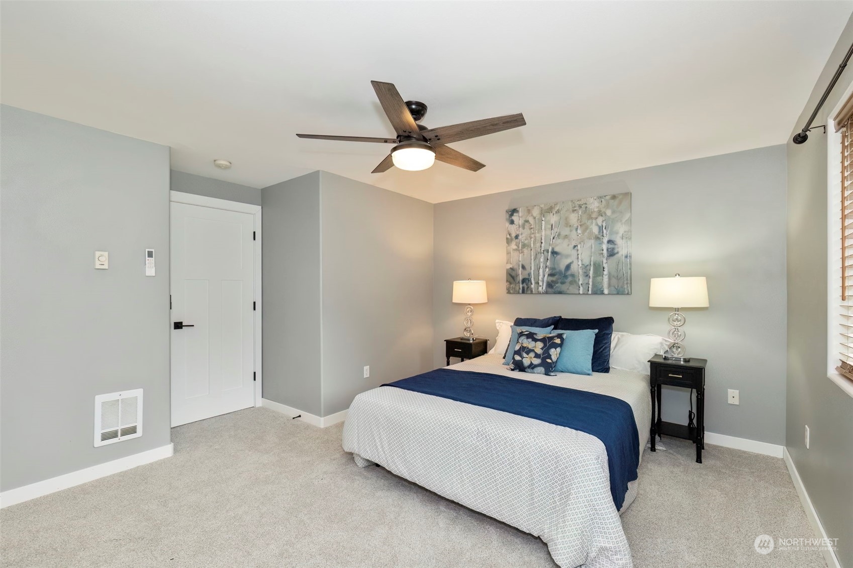 27474 Gamble Bay Road Northeast Kingston, WA 98346 - Photo 23 of 40 a bedroom with a bed and a painting on the wall