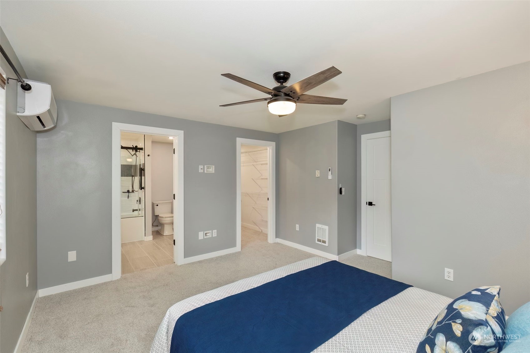 27474 Gamble Bay Road Northeast Kingston, WA 98346 - Photo 24 of 40 a bedroom with a bed and a chandelier