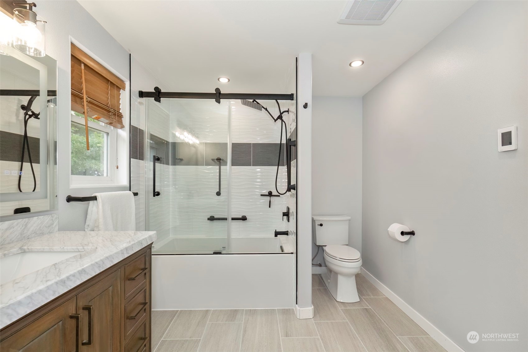 27474 Gamble Bay Road Northeast Kingston, WA 98346 - Photo 25 of 40 a spacious bathroom with a granite countertop sink a toilet and shower