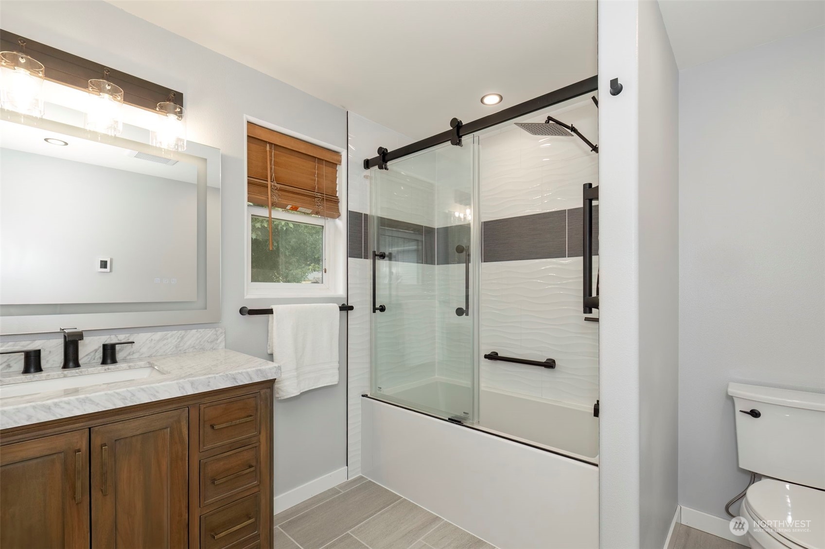 27474 Gamble Bay Road Northeast Kingston, WA 98346 - Photo 26 of 40 a bathroom with a granite countertop sink toilet and shower