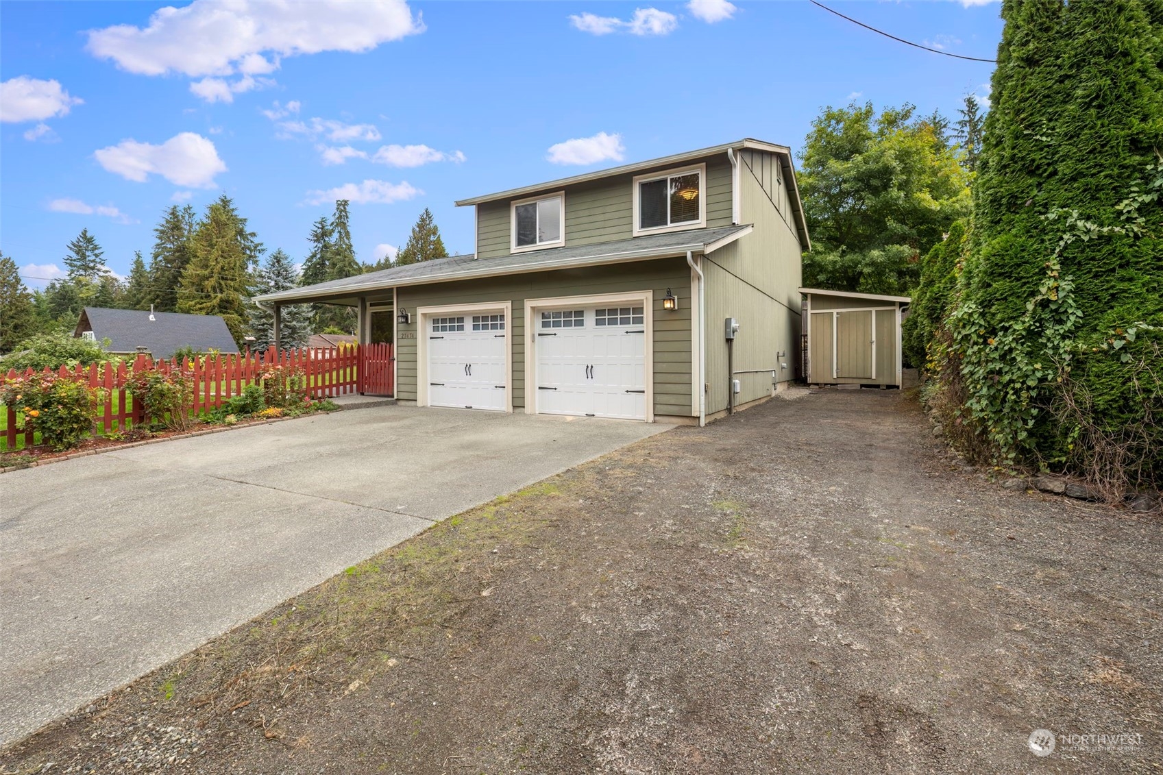 27474 Gamble Bay Road Northeast Kingston, WA 98346 - Photo 3 of 40 a front view of a house with a yard and garage