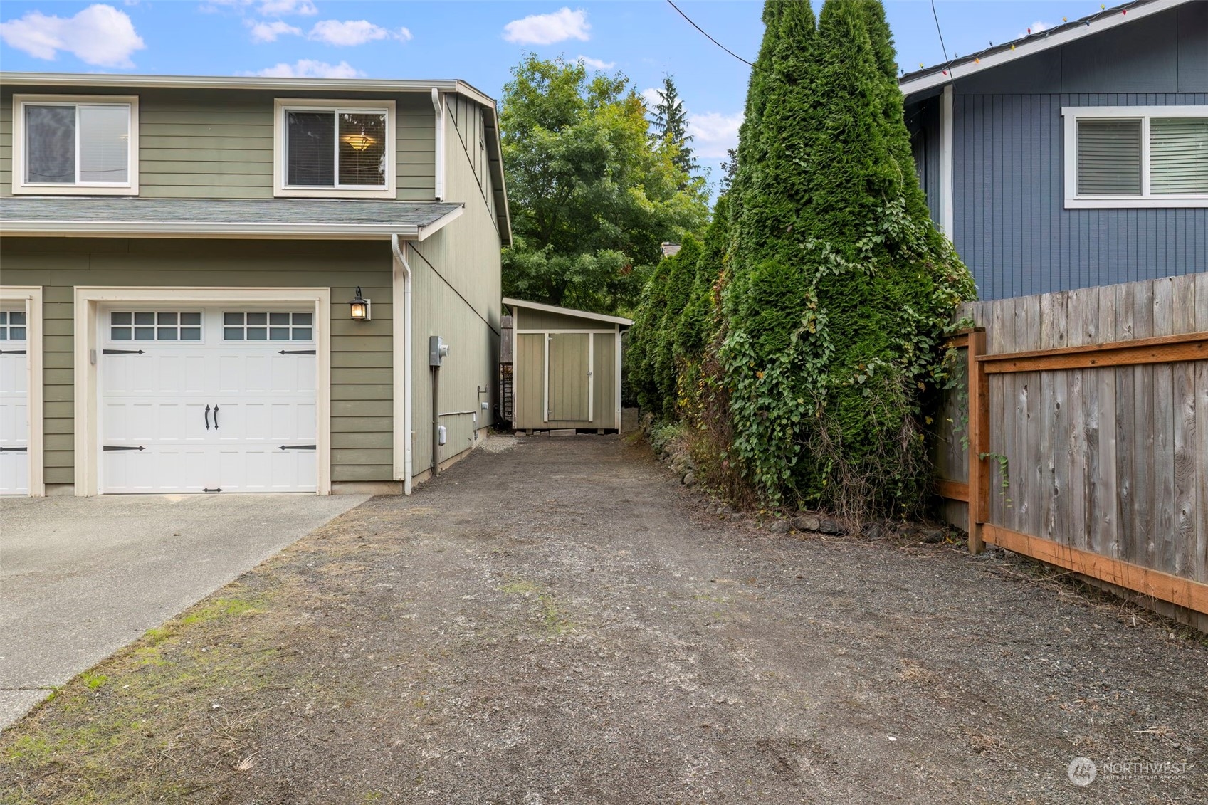 27474 Gamble Bay Road Northeast Kingston, WA 98346 - Photo 40 of 40 a view of a house with a backyard and garage
