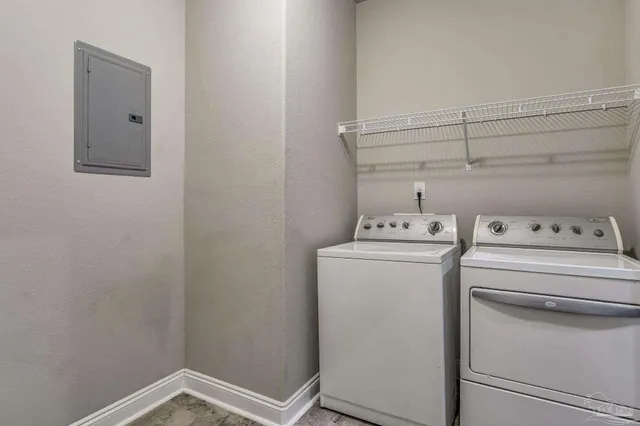 a kitchen with a refrigerator and white cabinets