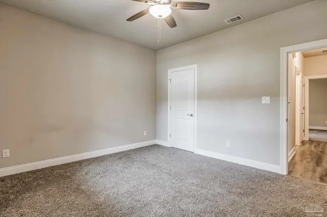 an empty room with windows and closet