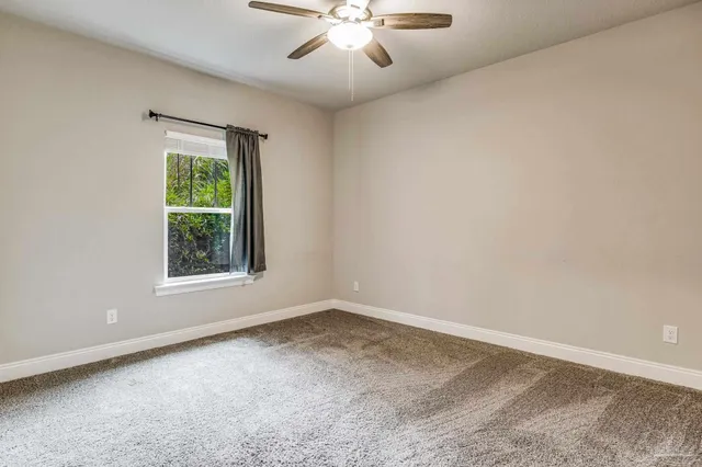 a bathroom with a granite countertop sink toilet mirror vanity and bathtub