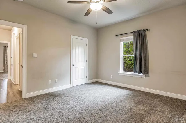 a bathroom with a granite countertop sink a toilet and a mirror