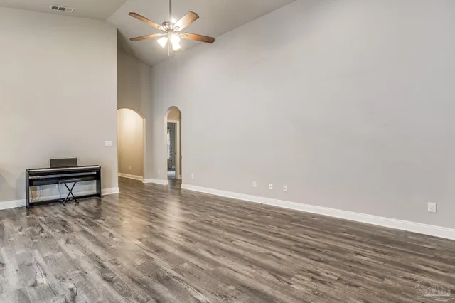 a view of kitchen with granite countertop stainless steel appliances refrigerator sink and cabinets