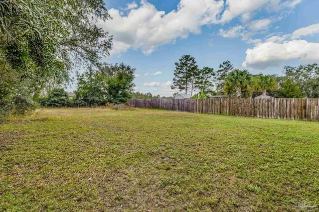 a house with huge green field in front of it