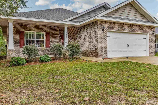 a spacious bathroom with a granite countertop sink and a mirror