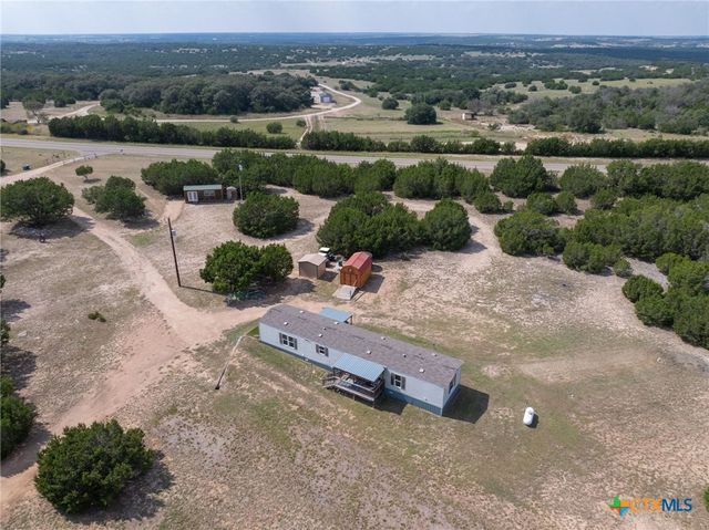 a view of house with yard and covered space