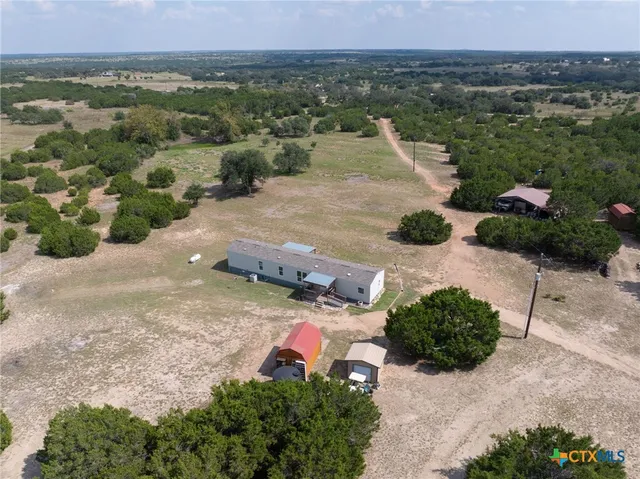an aerial view of a house with a yard