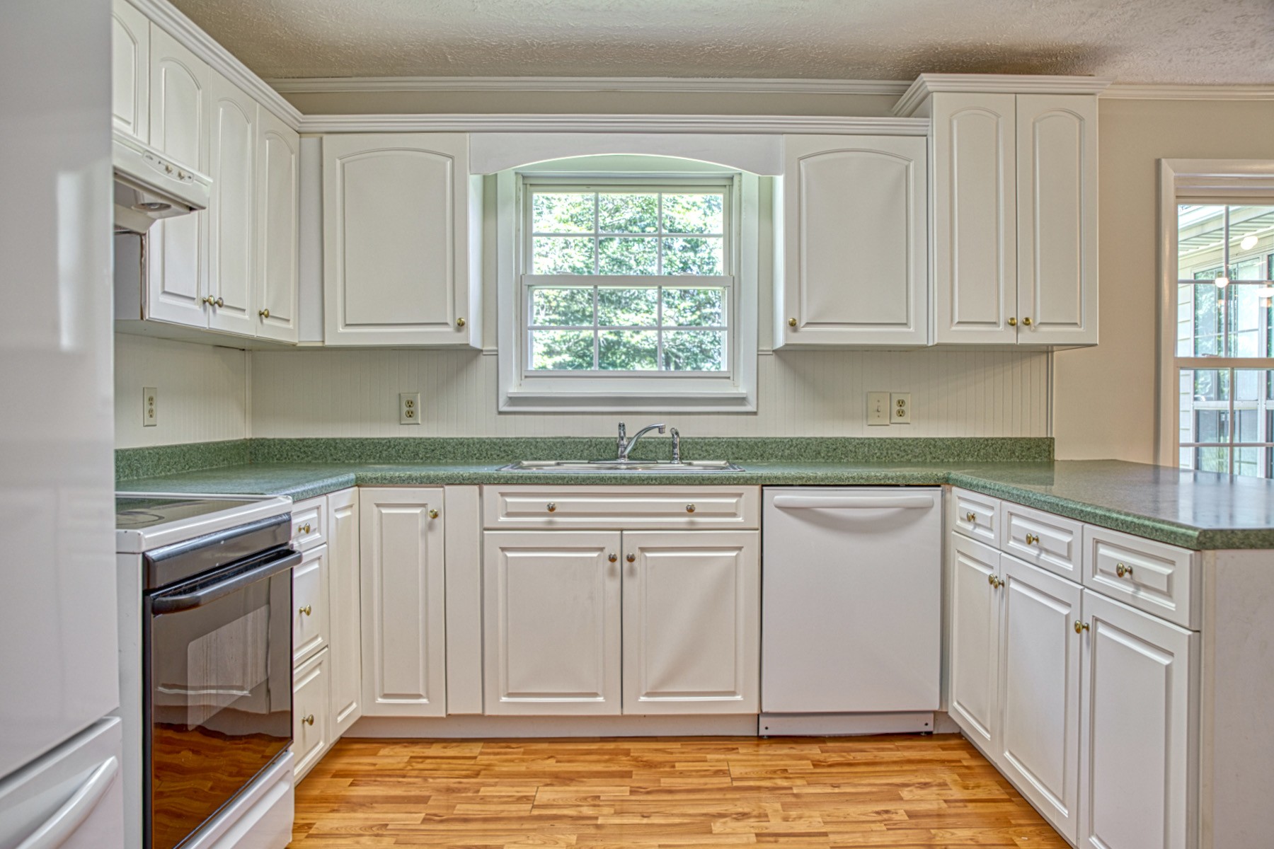 2085 Herbert Garrett Road Cookeville, TN 38506 - Photo 19 of 39 a kitchen with granite countertop white cabinets white appliances and sink