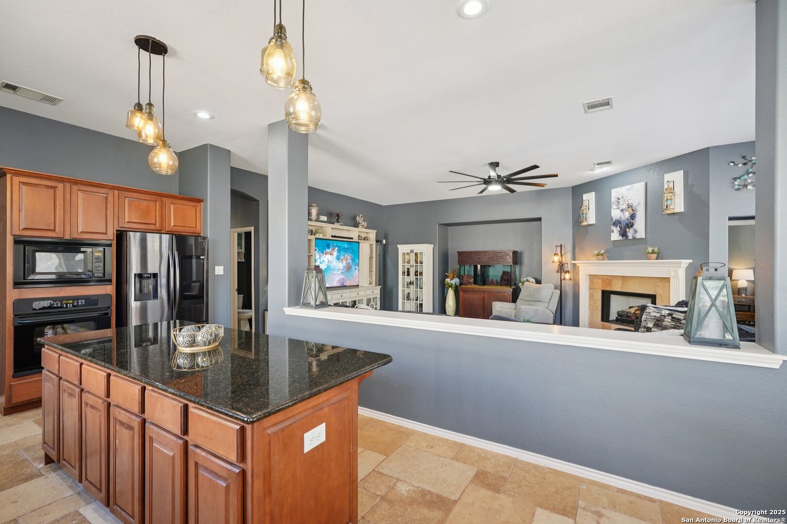 16107 Los Sedona Helotes, TX 78023 - Photo 12 of 59 a kitchen with stainless steel appliances granite countertop a sink a stove and a wooden floors