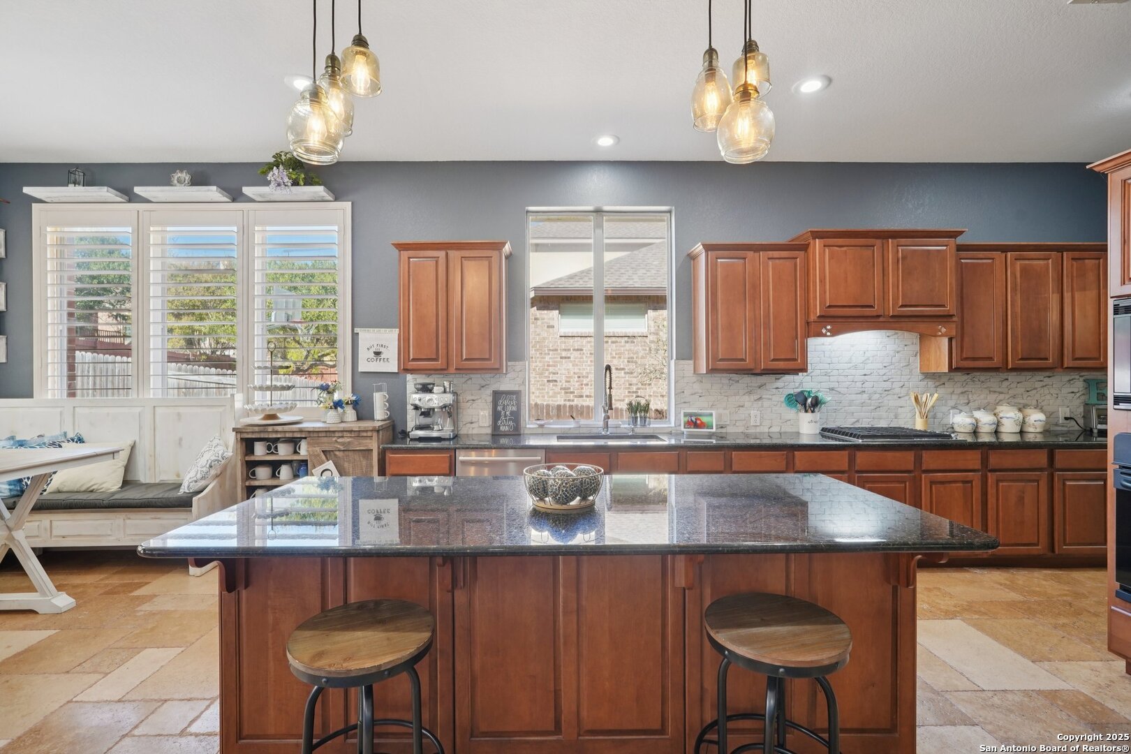 16107 Los Sedona Helotes, TX 78023 - Photo 16 of 59 a kitchen with granite countertop a stove a sink and a wooden cabinets
