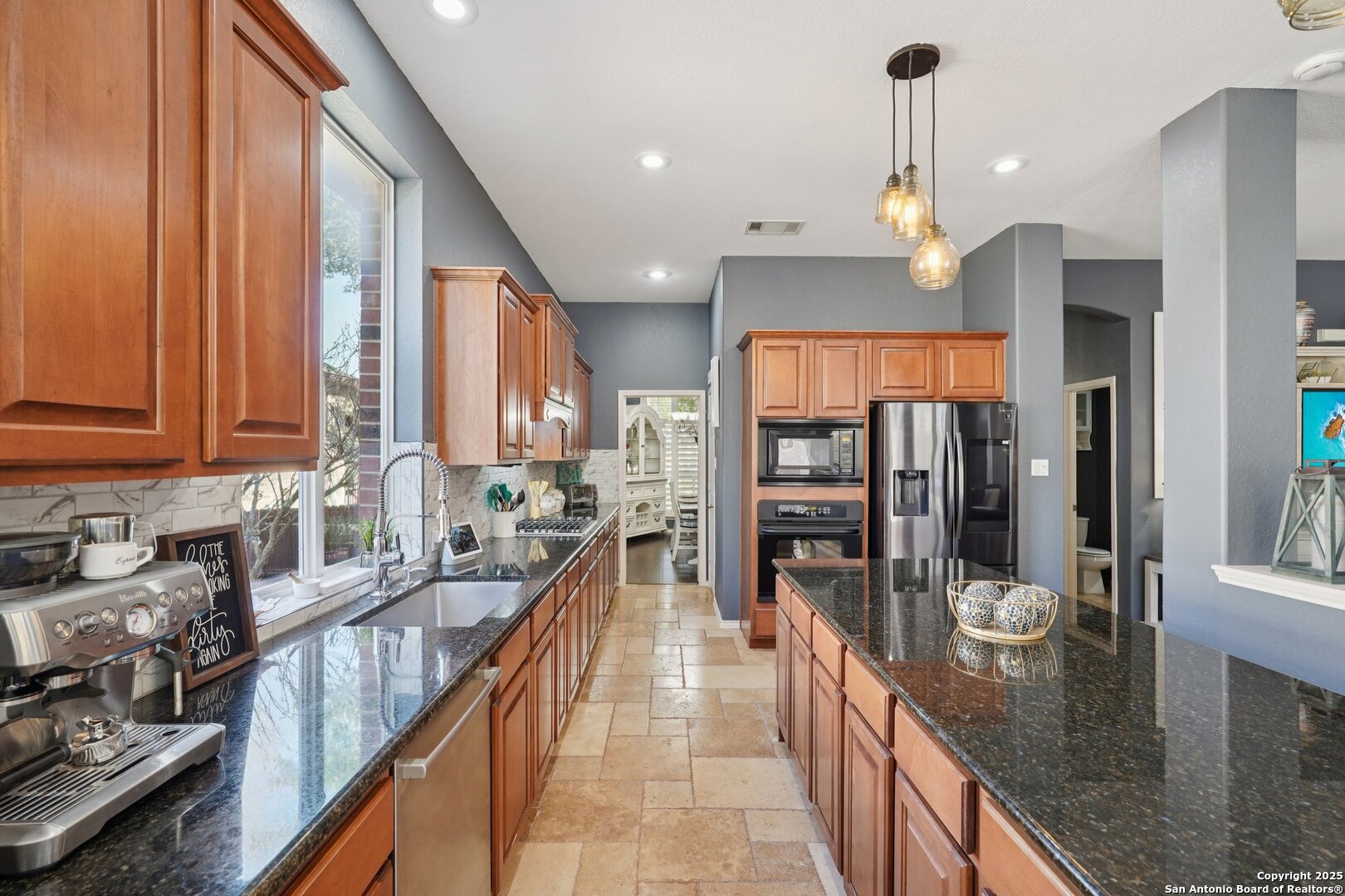 16107 Los Sedona Helotes, TX 78023 - Photo 18 of 59 a kitchen with stainless steel appliances granite countertop sink stove refrigerator and cabinets