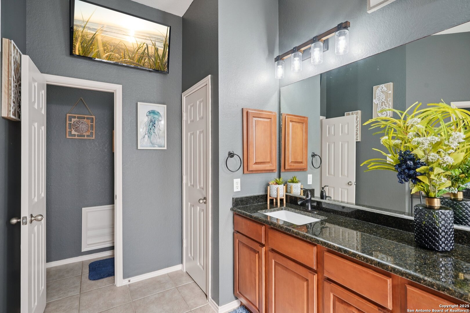 16107 Los Sedona Helotes, TX 78023 - Photo 27 of 59 a bathroom with a sink and a mirror