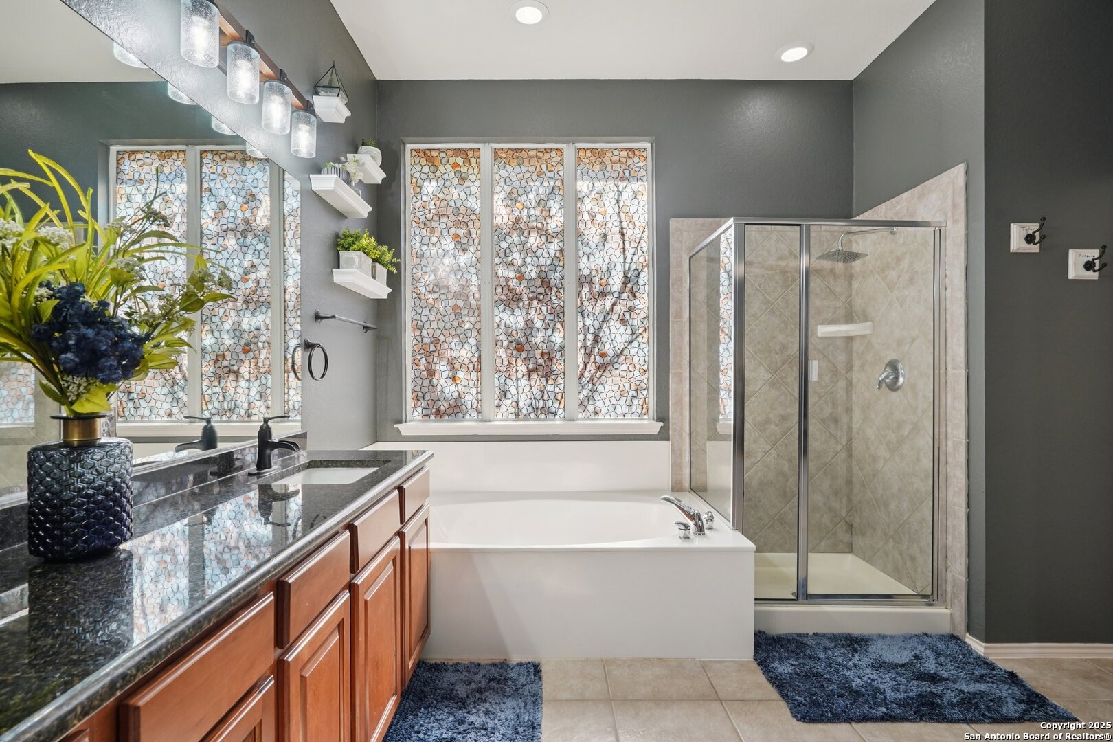 16107 Los Sedona Helotes, TX 78023 - Photo 28 of 59 a bathroom with a granite countertop bathtub a sink and a shower