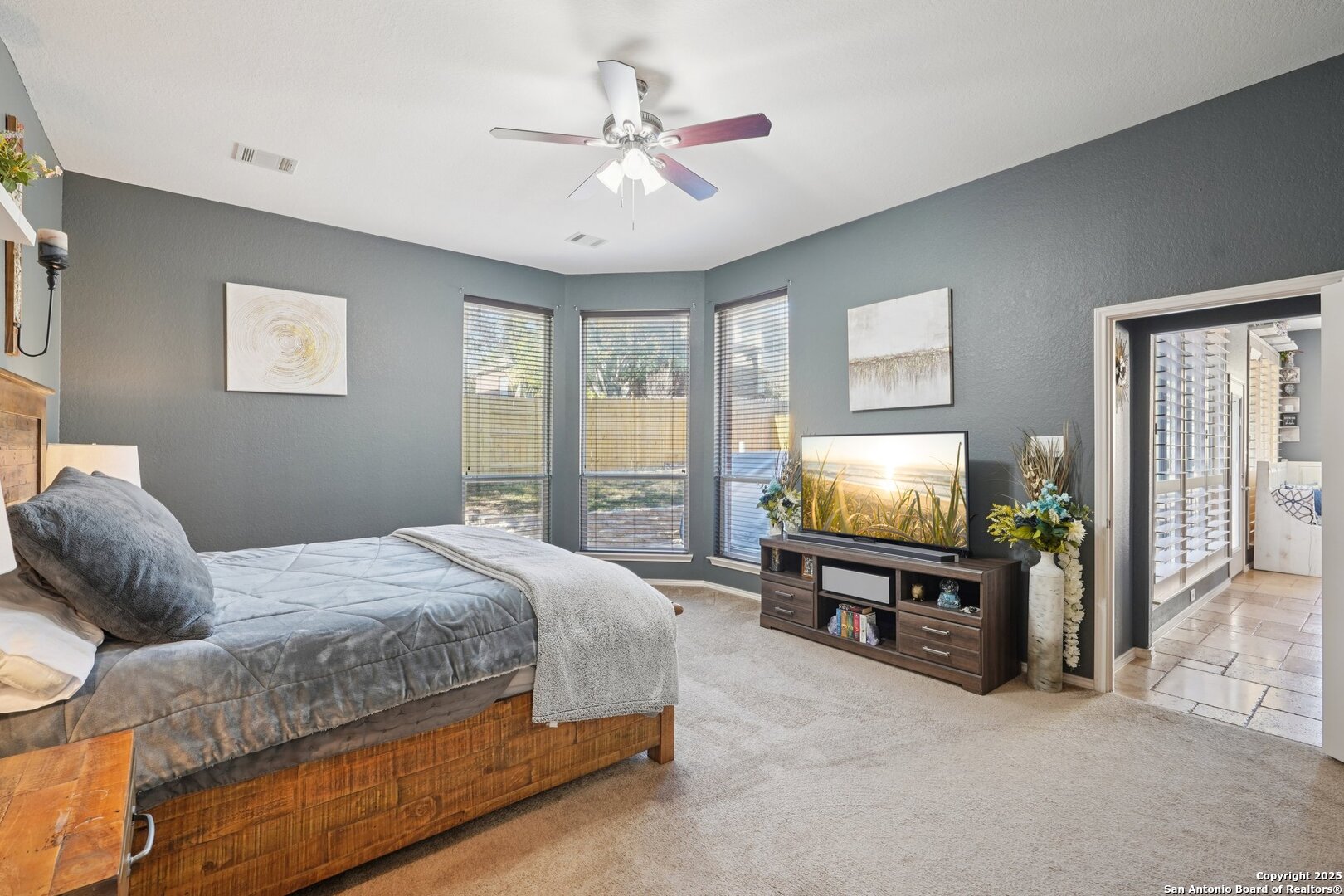 16107 Los Sedona Helotes, TX 78023 - Photo 31 of 59 a bedroom with a bed and a flat screen tv