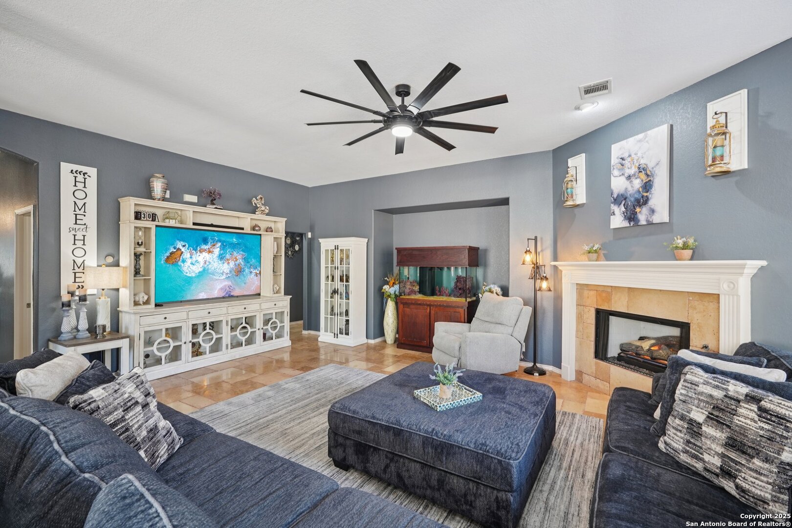 16107 Los Sedona Helotes, TX 78023 - Photo 32 of 59 a living room with furniture a fireplace and a flat screen tv