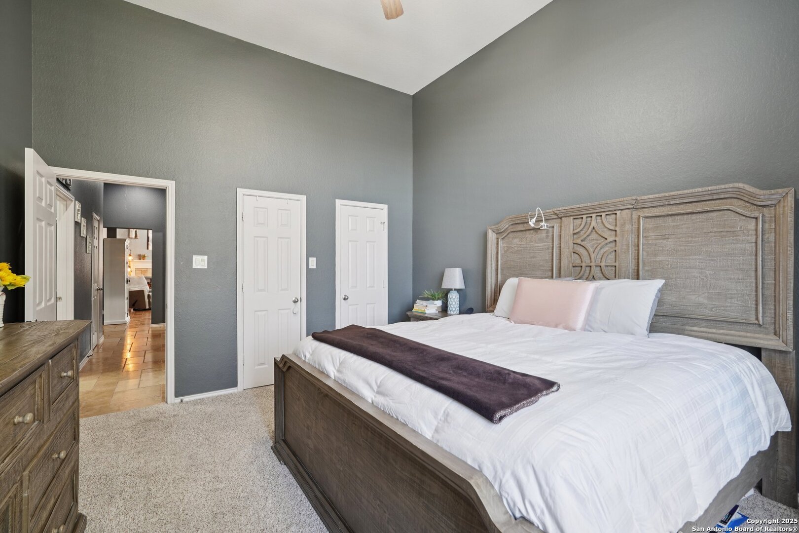 16107 Los Sedona Helotes, TX 78023 - Photo 34 of 59 a bedroom with a large bed and a dresser