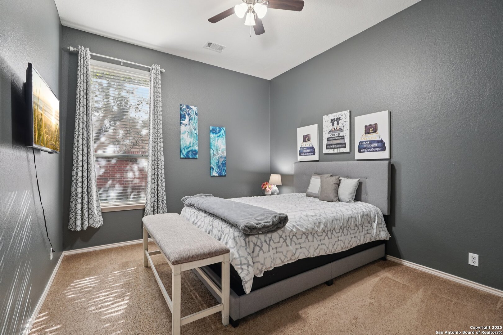 16107 Los Sedona Helotes, TX 78023 - Photo 37 of 59 a bedroom with a bed and a chandelier