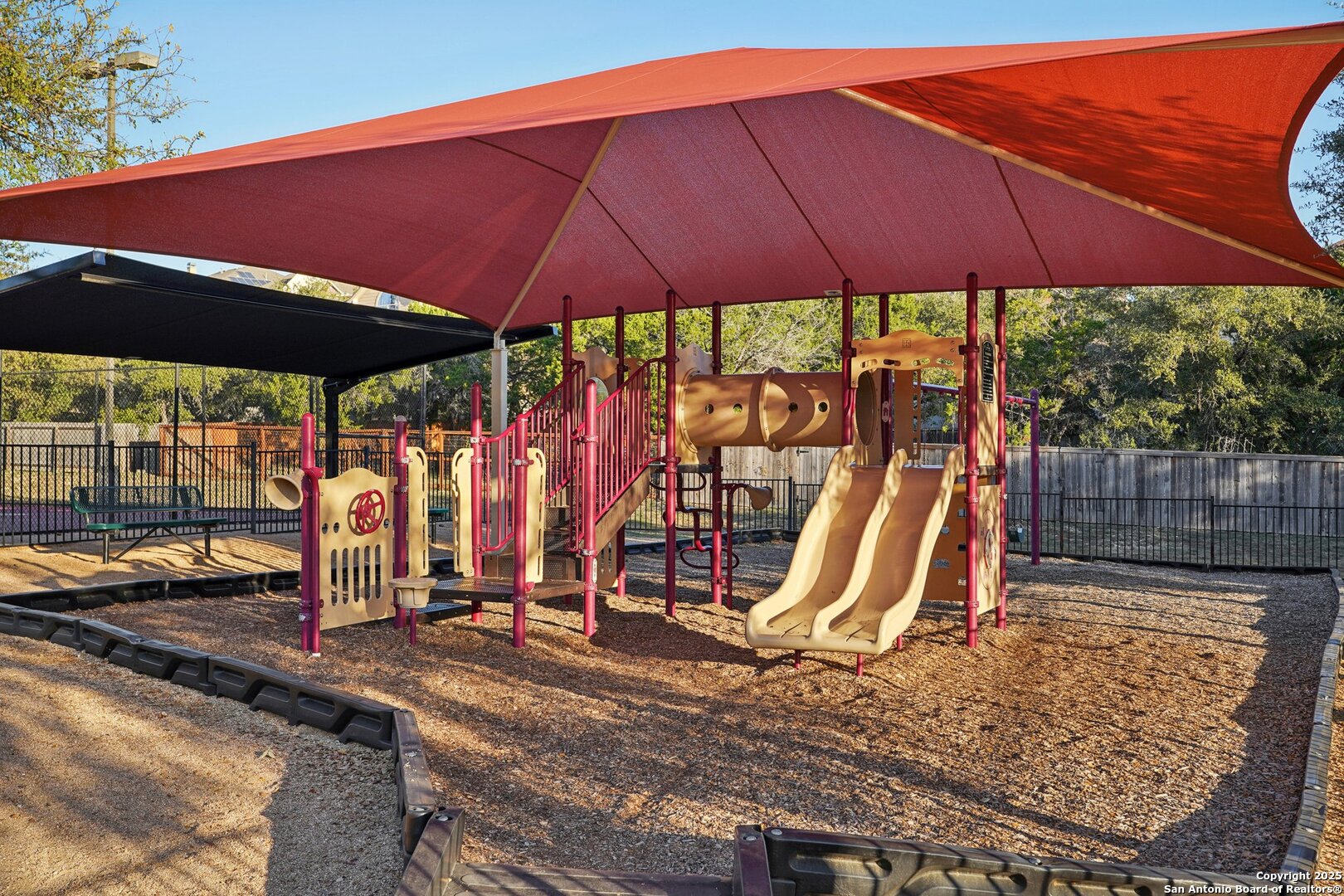 16107 Los Sedona Helotes, TX 78023 - Photo 51 of 59 a view of a backyard with a table and chairs under an umbrella