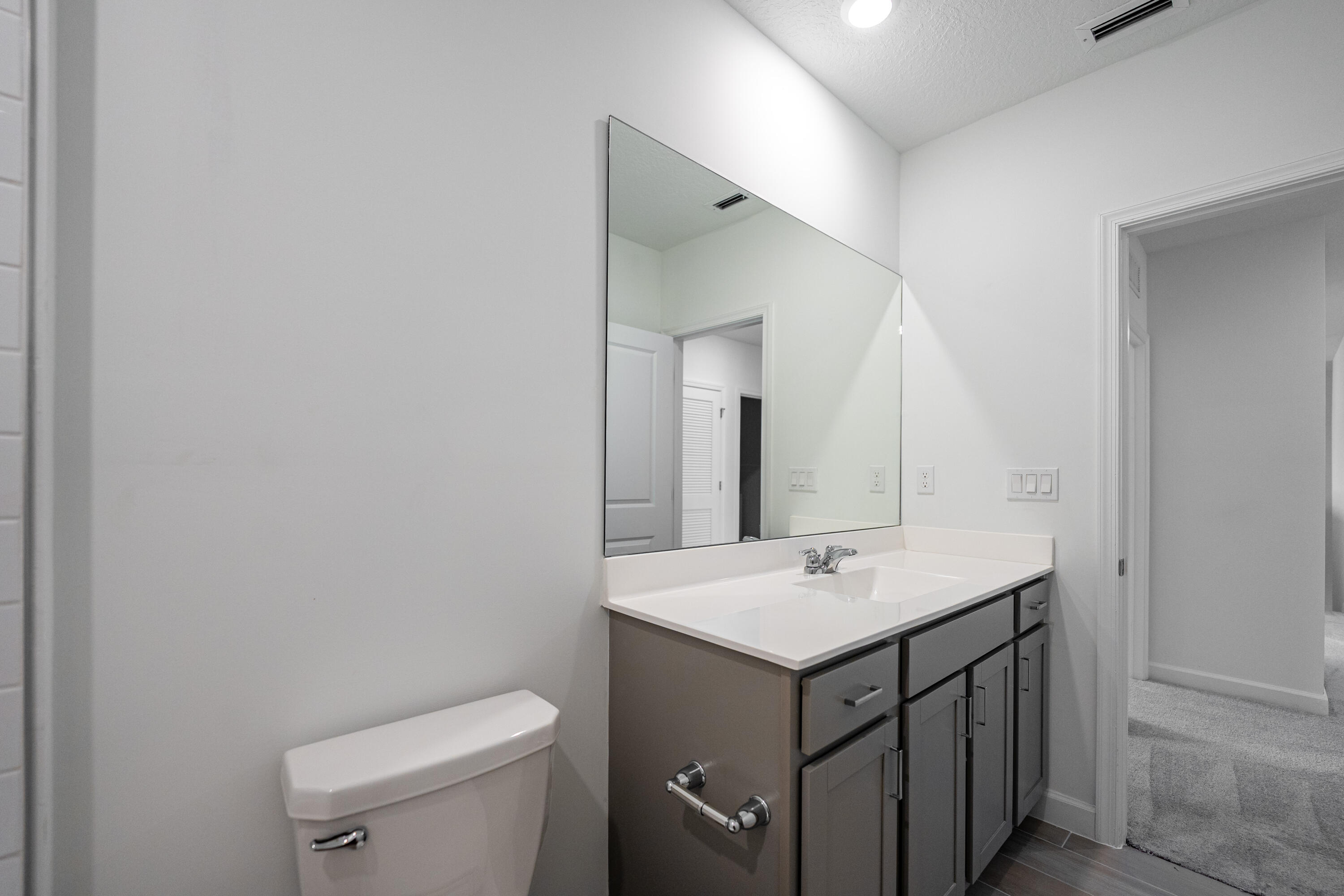 3544 Angler Drive Fort Pierce, FL 34946 - Photo 26 of 39 a bathroom with a sink a toilet and mirror