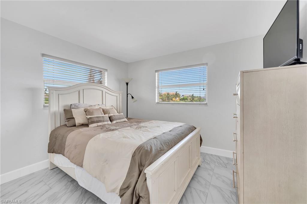 3065 50th Lane Southwest Naples, FL 34116 - Photo 18 of 31 a bedroom with a bed and a window