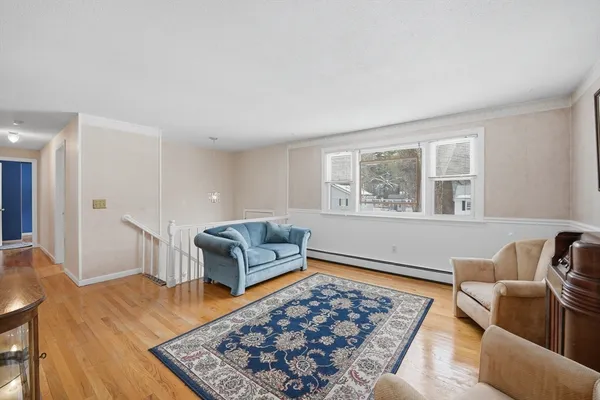 a living room with furniture rug and window