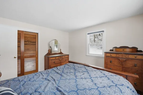a bedroom with a bed and dresser