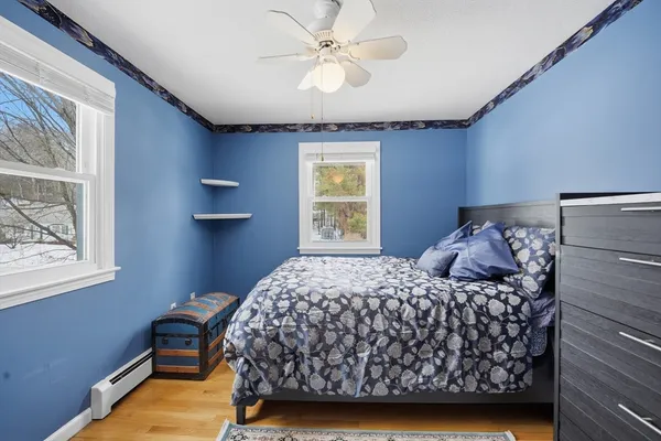 a bedroom with a bed dresser and a window