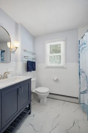 a bathroom with a toilet sink and mirror