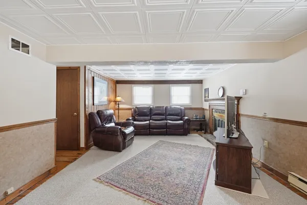 a living room with furniture and a chandelier