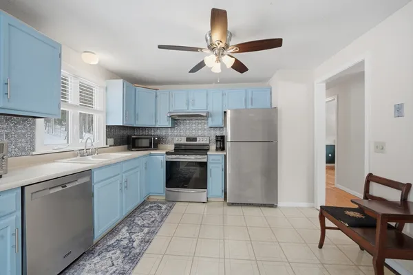 a kitchen with a refrigerator a sink and a stove