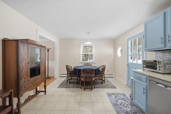 a dining room with furniture and window