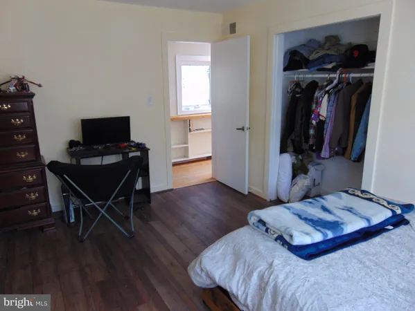 a bedroom with a bed and a chair