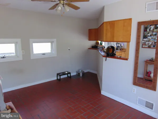 an empty room with windows and closet