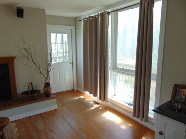 a very nice looking room with wooden floor and a window
