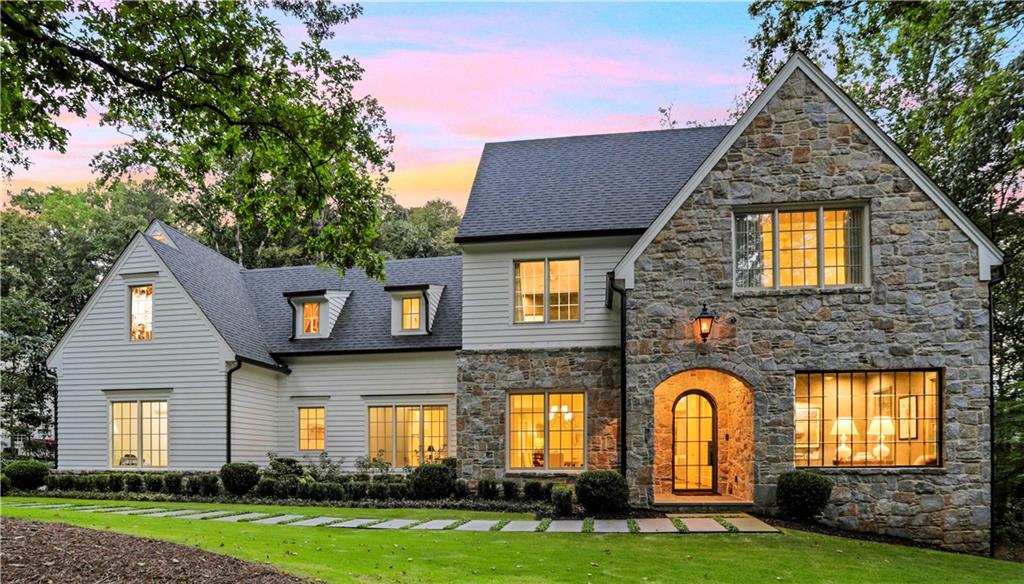 a front view of a house with a garden