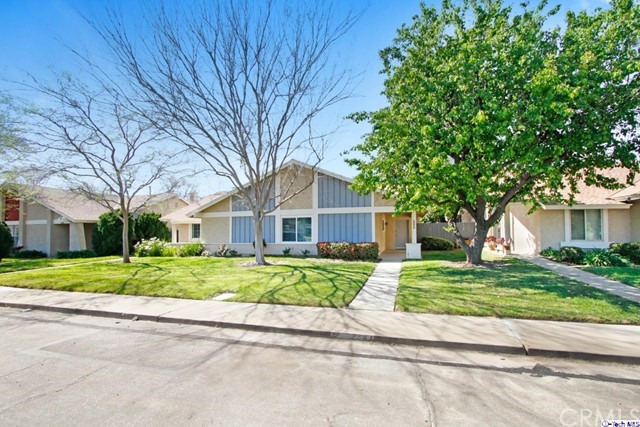 2347 Workman Avenue Simi Valley, CA 93063 - Photo 1 of 1 a brick house next to a yard with large trees