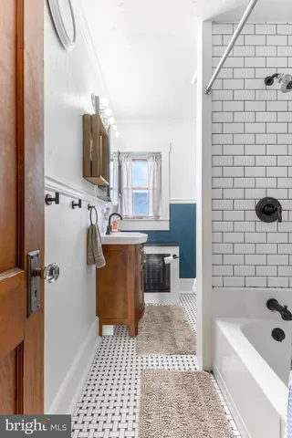 a bathroom with a sink a toilet a mirror and shower