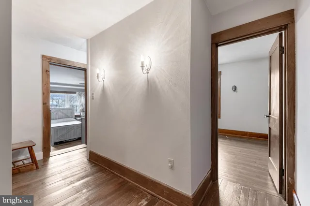 a view of livingroom with hardwood floor and a hallway