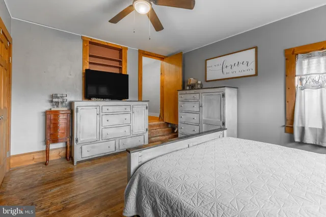 a bedroom with furniture and flat screen tv