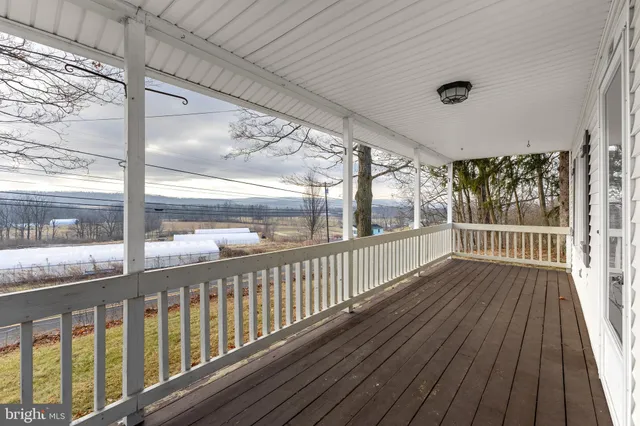 a view of a balcony with wooden floor
