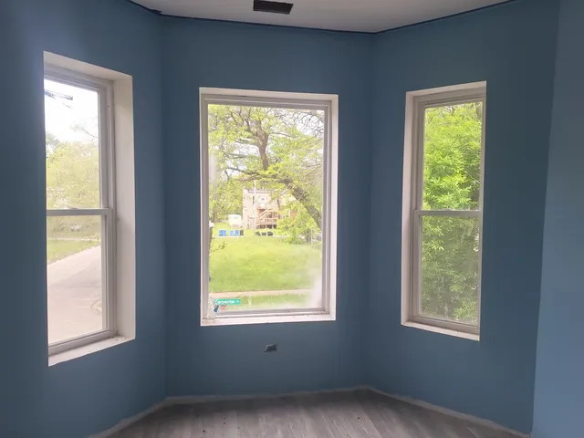 a view of an empty room with windows