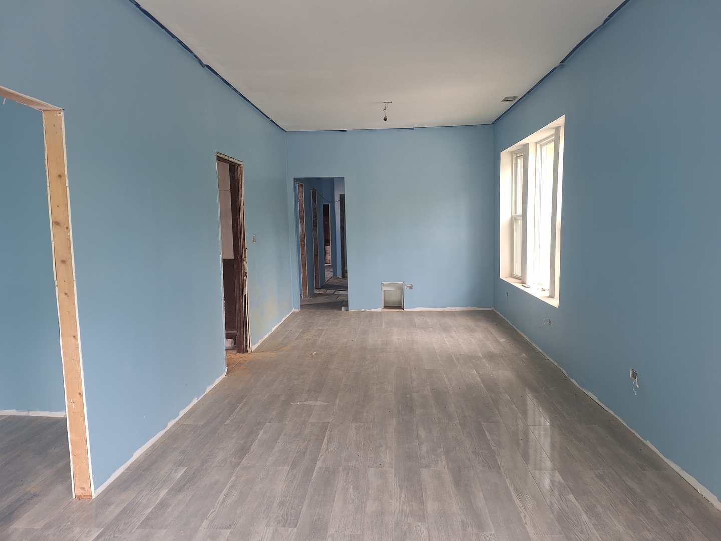 5757 South Carpenter Street Chicago, IL 60621 - Photo 10 of 18 a view of an empty room with wooden floor and a window