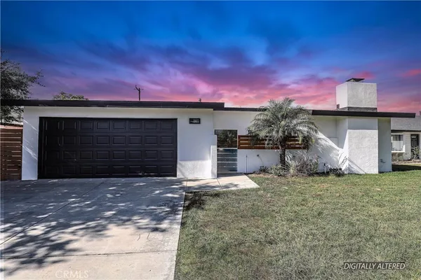 a view of a house with a yard and garage