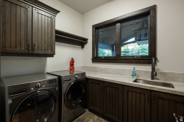 9156 Forest Road, Unit 24 Heber City, UT 84036 - Photo 26 of 42 Laundry area featuring dark wood-finish cabinetry, a single basin sink with a matte black faucet, and light-toned countertops