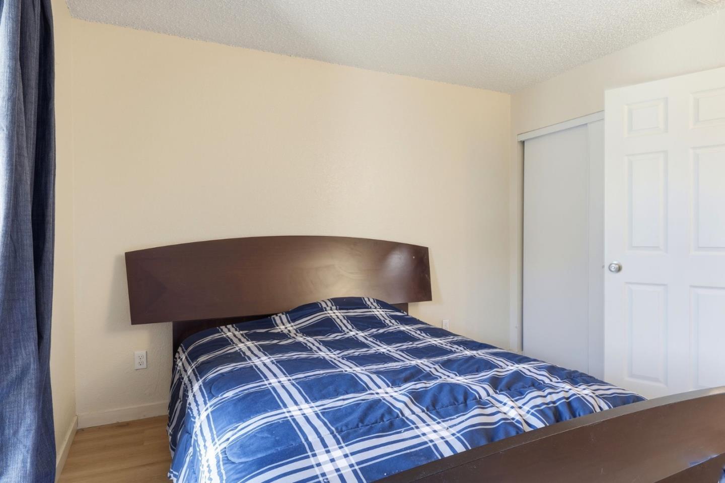 7283 Florin Road, Unit 8 Sacramento, CA 95828 - Photo 22 of 35 a bedroom with a bed and pillows