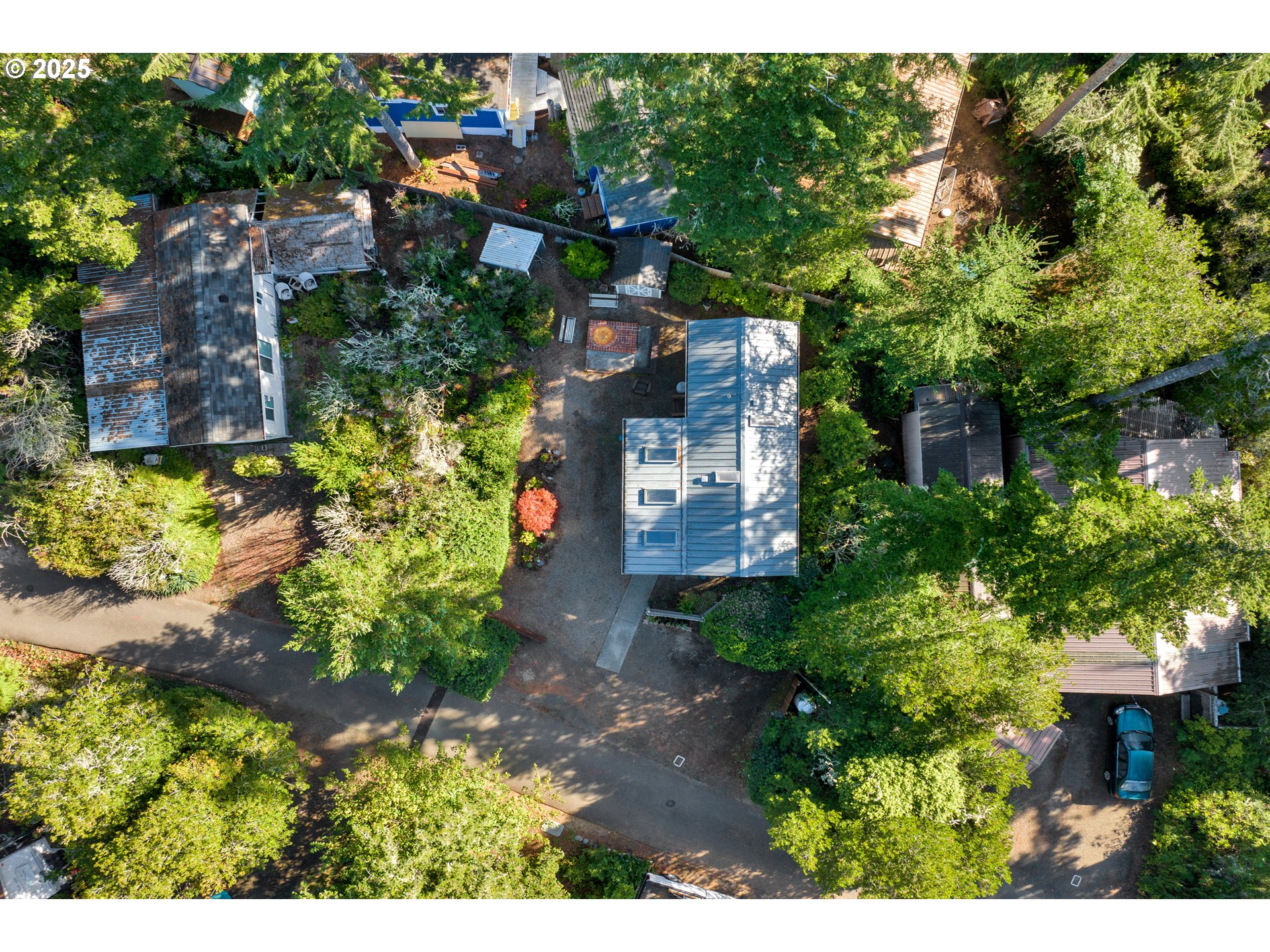 225 Azalea Street Florence, OR 97439 - Photo 14 of 15 a view of a house with a yard and garden